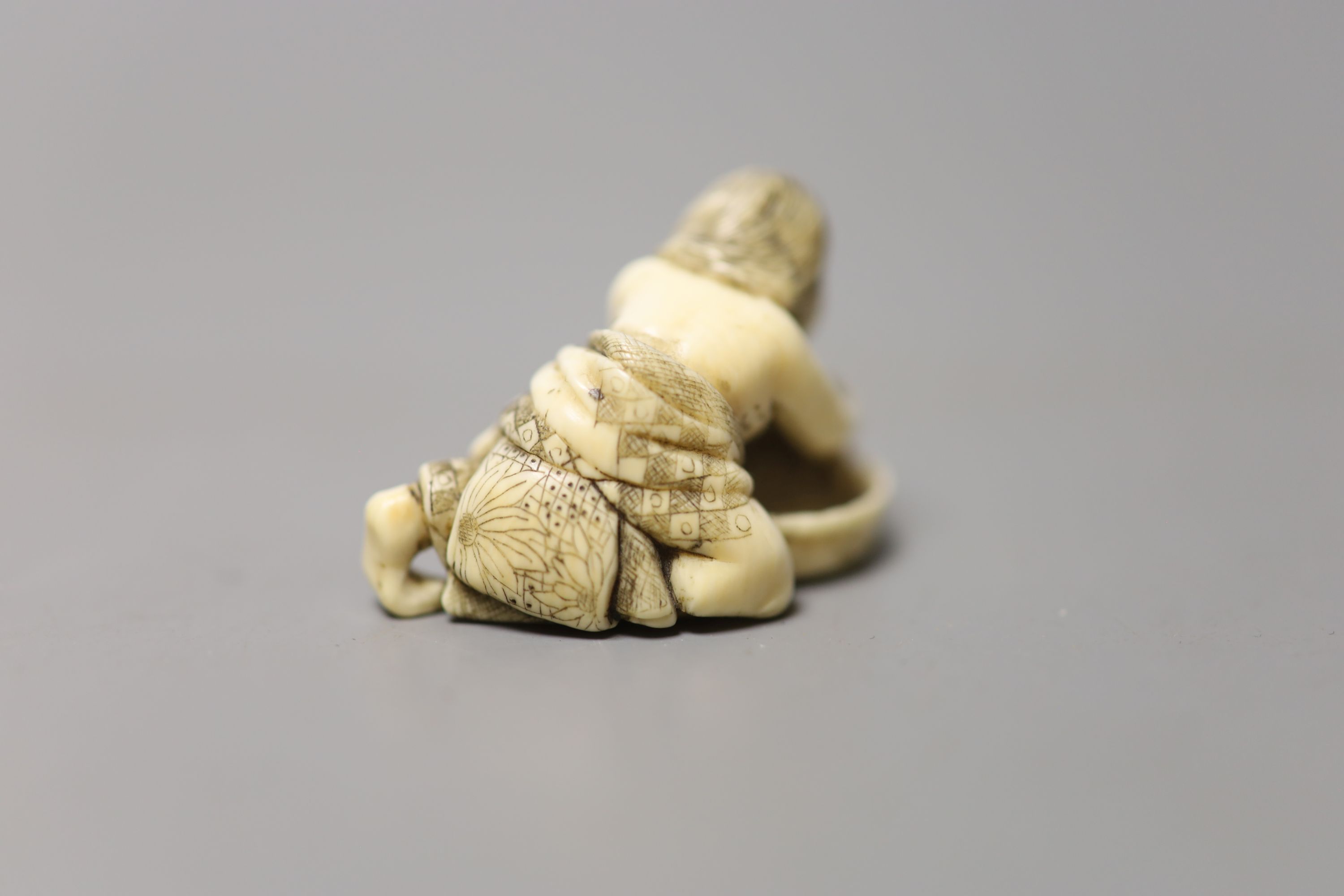 A 19th century Japanese ivory netsuke of a woman washing her hair, 3.5cm wide